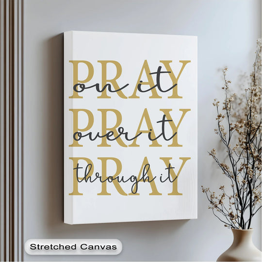 Displayed is a premium canvas decor piece featuring the inspirational phrase 'Pray On It, Pray Over It, Pray Through It' in elegant gold and black tones.