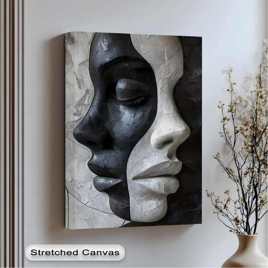 A vertically oriented rectangular canvas art piece depicts an abstract design of contrasting faces in black and white tones, creating modern wall art.