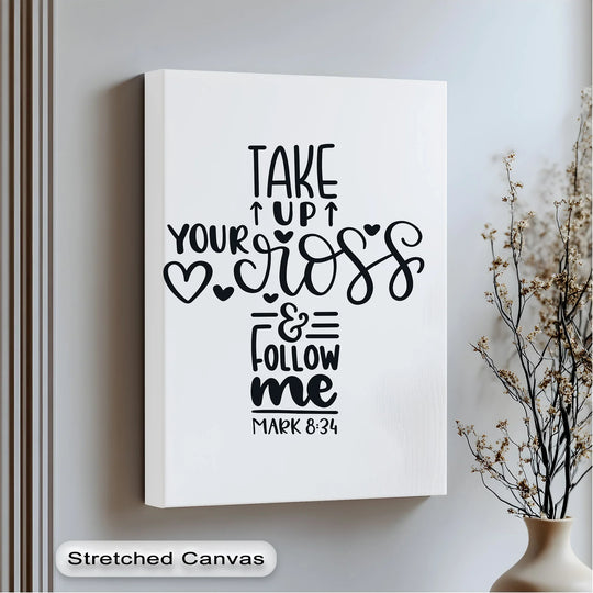With flourishing letterforms, the Take Up Your Cross canvas painting features heart-shaped accents and vine-like curves, adding gentle shapes to the design.