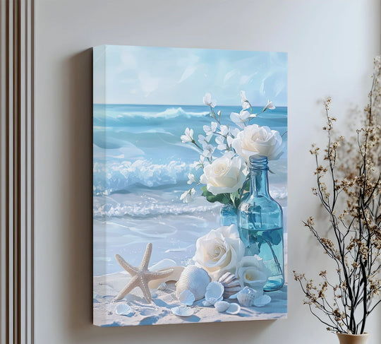 Gentle petals of white roses on the beach create a dreamy focal point in these ocean breeze canvas pictures, complemented by shells, a starfish, and blue water.