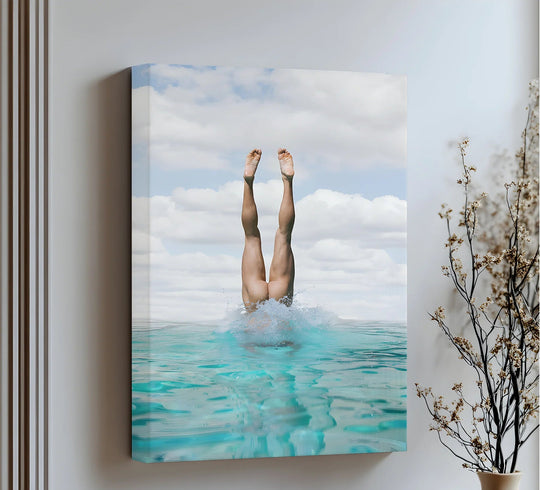 Centered on the focal point, a captivating canvas wall art print showcases a diver plunging into turquoise waters beneath a serene sky.