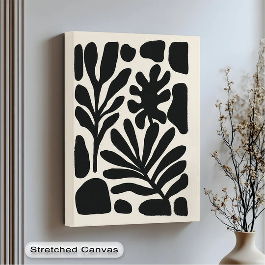 Foreground showcases a minimalist black and beige botanical silhouettes as a unique canvas print, stretched to create a modern wall art accent.