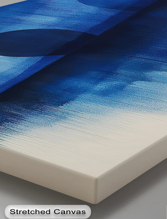 Negative space accentuates the minimalist design of this abstract indigo canvas print, highlighting the water and spheres of this premium canvas decor.
