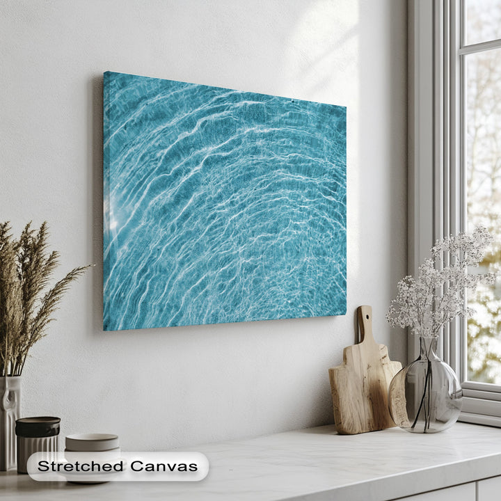 A horizontal rectangular big canvas print showcases a vibrant blue water ripple texture, offering abstract ocean wall art.