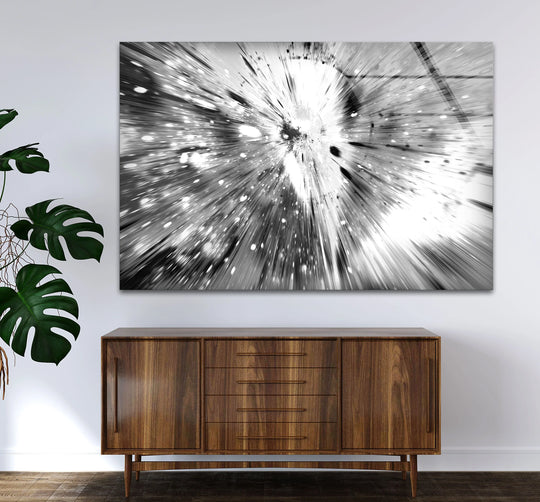 A detailed shot of a unique modern wall decor featuring a monochrome abstract glass print of an explosion with bright white light streaks.