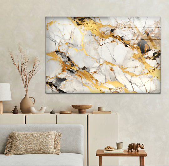 A minimalist beige wall offers ample negative space for a striking white and gold marble print wall art.