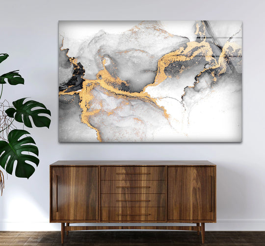 Abstract geometric shapes flow with gold accents in this unique modern wall decor glass print.