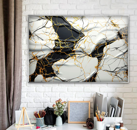 A chic, high-color-temperature glass art print captures abstract swirls of black, white, and gold marble for a luxurious statement piece.