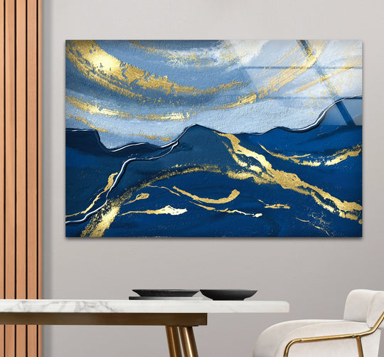 A premium glass wall art print featuring textured navy and sapphire hues with radiant gold accents creating an oceanic flow.