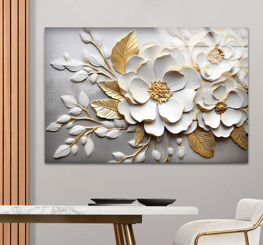 Displaying the organic forms of white and gold flowers, this glass wall art decor piece showcases elegant 3D textured floral designs on a glass panel.