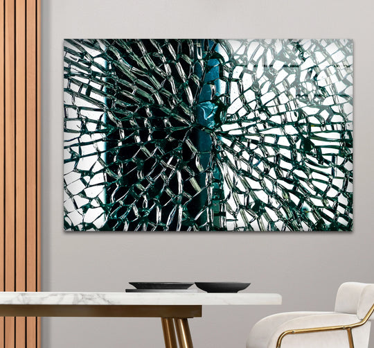 Close-up view of shattered abstract art from glass with deep teal fragments and sharp edges.