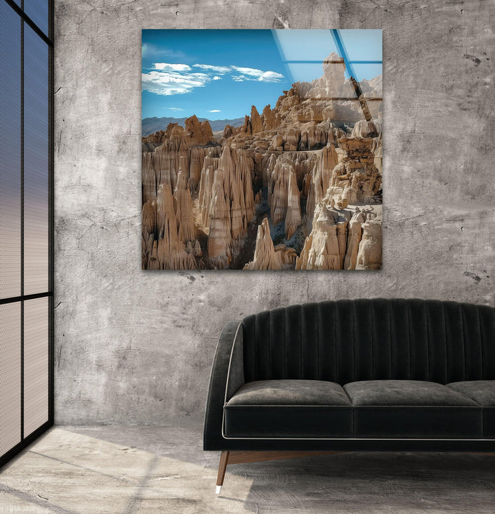 Glass wall art displaying the sharp details of weathered sandstone formations.
