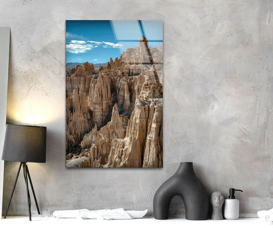 Warm hues dominate this canyon rock formations scene, giving a sense of the desert sun in this glass wall artwork, while the blue sky offers a cool contrast.