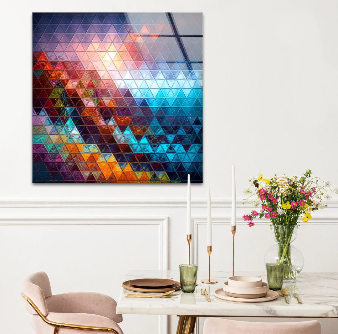 The subtle color transition between vibrant blues, oranges, and purples defines this geometric prism glass wall artwork, a mosaic of colorful triangles for modern decor.
