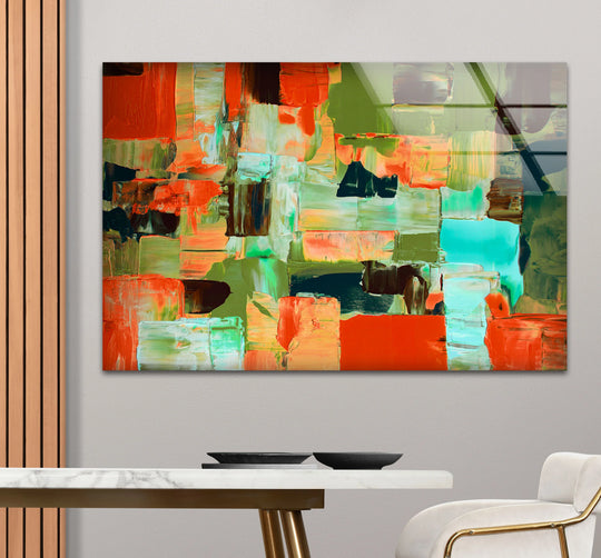 A plush cream chair with subtle curves offers the softest element against the abstract glass wall art.