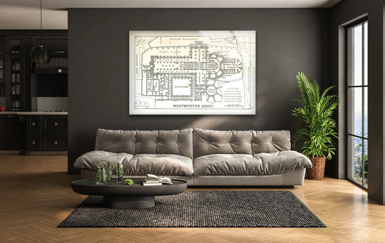 Foreground detail shows a stylish coffee table with refreshments and a book in front of the Westminster Abbey floor plan wall prints.