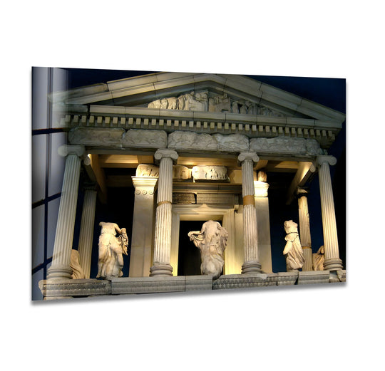 Set against a dark backdrop, the illuminated Temple of Athena's glass print wall art highlights the majestic ancient Greek architecture at night.