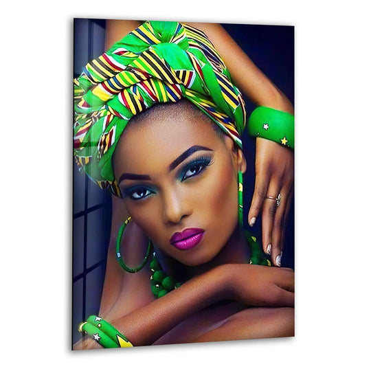 A close-up of a striking African woman's face showcases the glossy texture of the print wall art with her vibrant green headwrap and striking makeup.