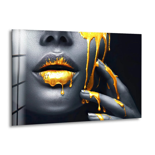 Glass wall art featuring a black woman with gold lips and dark grey skin dripping with yellow paint and a matching painted hand cool wall art