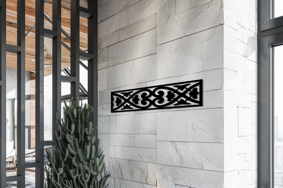 Laser-cut ornamental metal wall art with symmetrical pattern