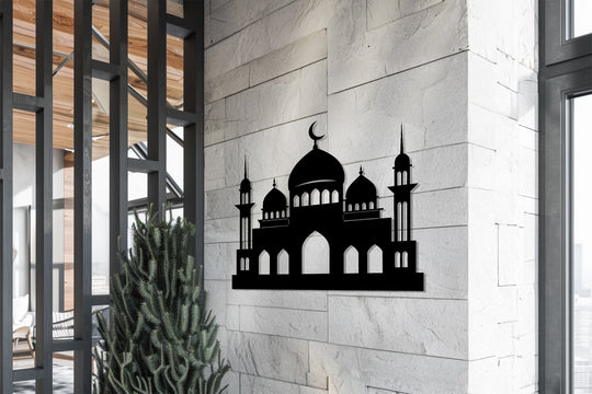 Intricate metal wall decor silhouettes a grand mosque, the loudest element showcasing Islamic architecture as a striking example of metal wall art against a textured wall.