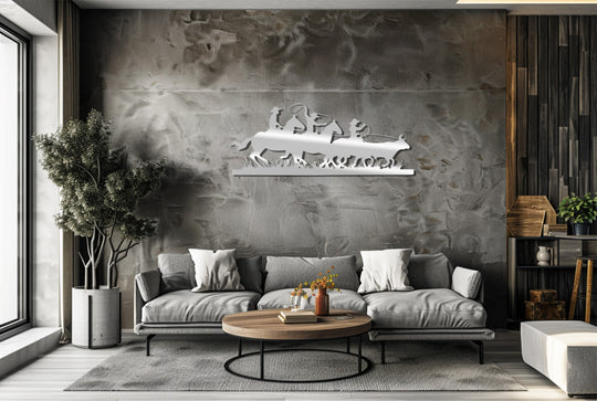 Negative space highlights the Western Cowboy Silhouette metal art for wall, portraying horses and cowboys in a dynamic rodeo scene above a modern living room.