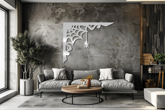 Negative space defines the intricate spiderweb design of this metal artwork, creating a visually striking gothic metal artwork corner piece.