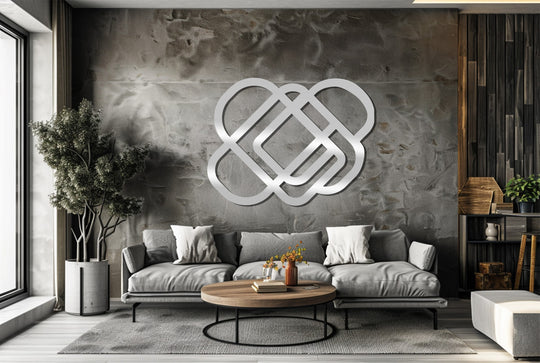 Observing the color transition on the decorative metal art, the minimalist interwoven geometry shifts from a bright silver to shadowed hues, enhancing the wall's texture.