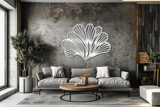Gray dominates this modern living room showcasing abstract leaf fan metal wall decor, a botanical design that adds a touch of contemporary elegance.