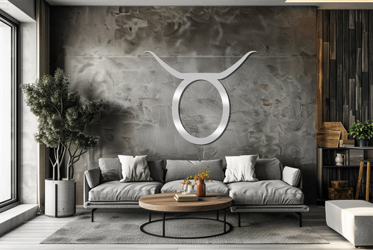 Centered on the textured wall, the silver Taurus zodiac symbol constitutes a piece of unique metal wall art, adding an astrological accent to the modern living space.