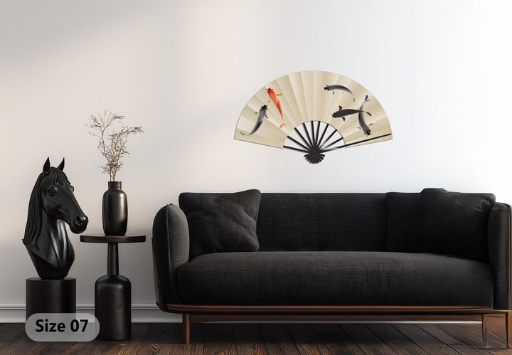 Brightest area highlights the exquisite decorative metal art of this elegant Koi fish fan, showcasing a Japanese-inspired design.