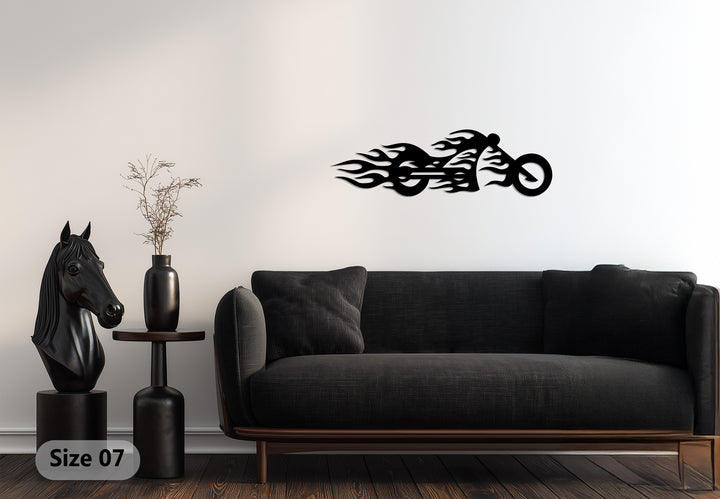 Illuminated by the brightest area, a black metal flaming motorcycle decoration wall art stands out against the white wall.