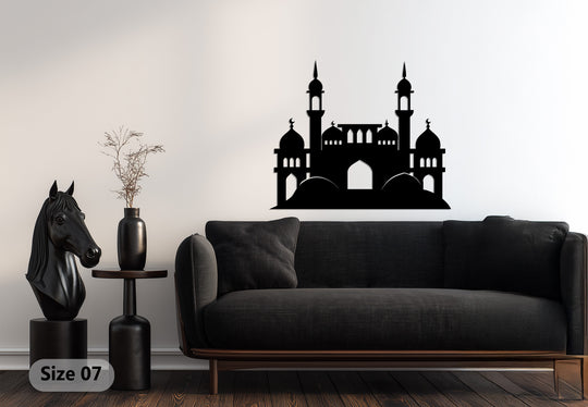 The minaret’s sweeping organic forms contrast with the sharp edges of the Islamic metal artwork, featuring a silhouette of a mosque with its domes.