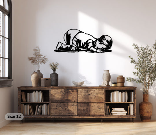 Highlighting the abstract quality, this decorative metal art depicts a child in prostration, forming a powerful symbol of prayer through minimalist lines and a sleek, modern aesthetic.
