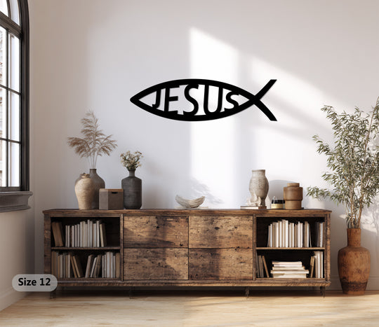 Black decorative metal art finish accentuates the Ichthys faith Jesus fish Christian metal wall art on a neutral wall in a cozy room.