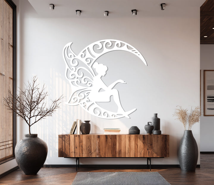 Decorative metal wall art of fairy sitting on crescent moon