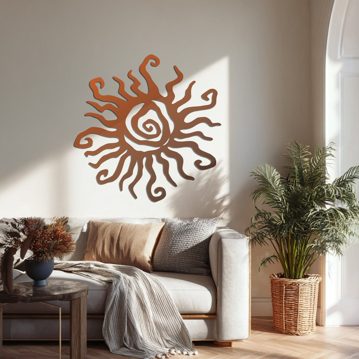 Rustic copper finish of the abstract sun decoration wall art, a bohemian spiral sunburst metal decor, is highlighted by the soft light in this living space.