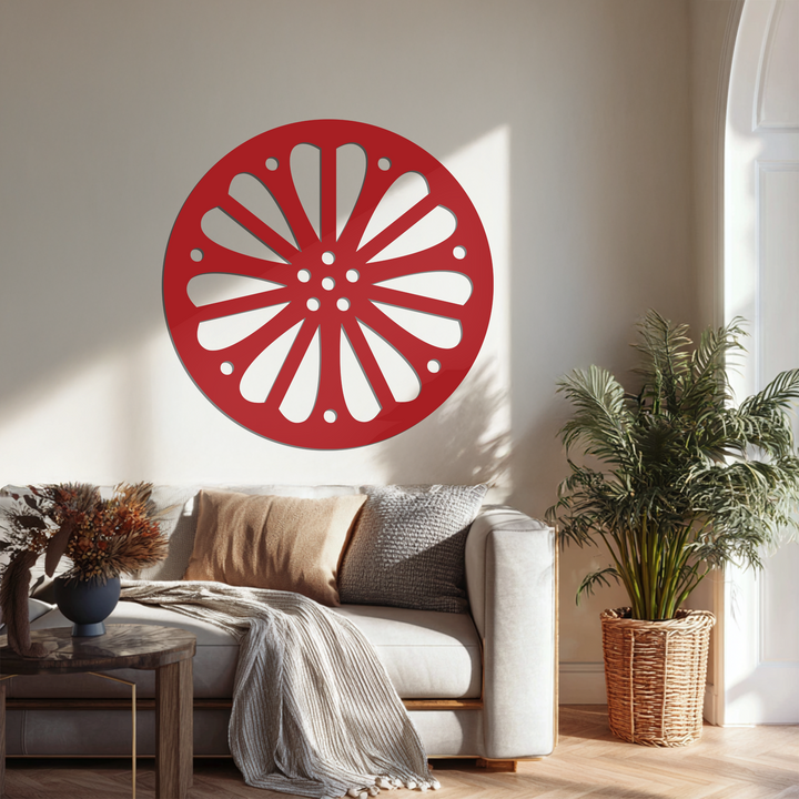 Sunlight softly illuminates the metal art for wall, highlighting the radiating petal pattern of this modern round piece.