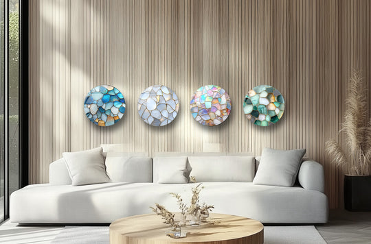 Round set glass wall art displays a pebble mosaic design and ocean inspired decor
