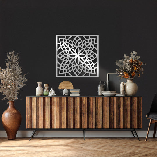 Foreground shows a striking square interwoven mandala metal wall decor piece, presenting sacred symmetry for a modern and minimalist space.