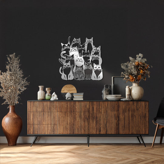 Against the textured, dark gray background, the modern metal wall decor of a cat family artwork in golden tones creates a striking contrast.