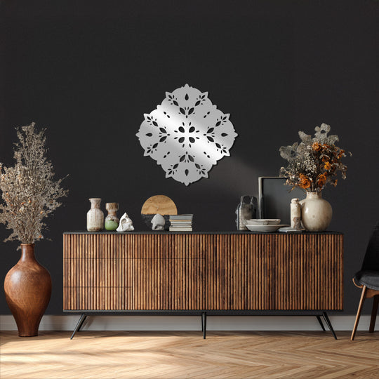 Focusing on the brightest area, the gleaming floral crown mandala metal art for wall shines as an elegant, laser-cut home decoration against the textured dark wall.