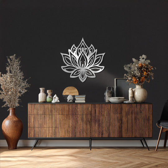 Light and shadow play across the decorative metal art of a sacred lotus flower wall hanging, highlighting its intricate design and spiritual form.