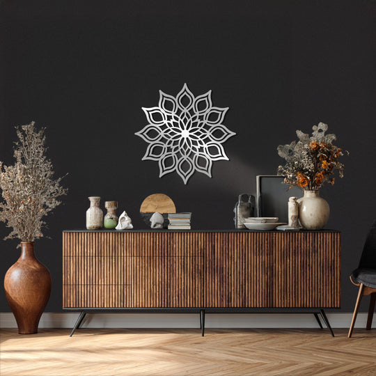 Dark, textured background accentuates the unique metal wall art, a radiant lotus mandala, displayed as part of zen and modern home decor.