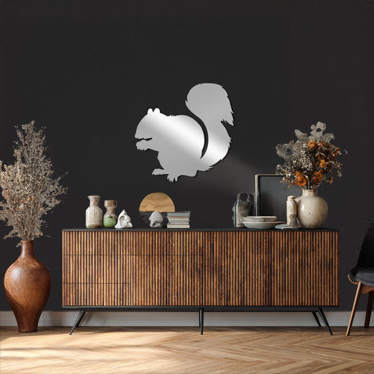 Reflecting light, the modern squirrel silhouette metal artwork acts as the loudest element, showcasing exquisite metal artwork on a dark wall above a console table.