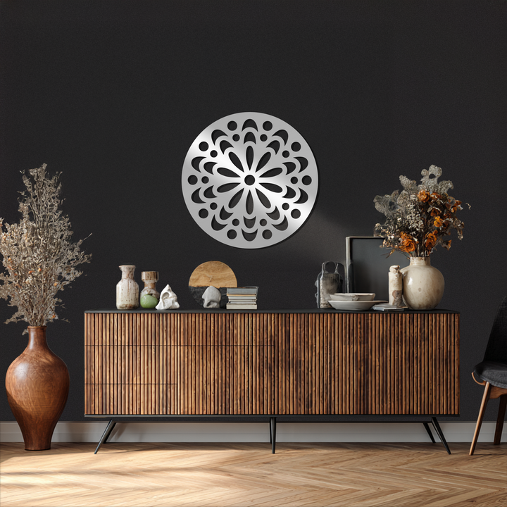 Depth is created by the silver, ornamental floral mandala metal wall art that casts shadows, adding unique metal wall art layers on the dark wall.