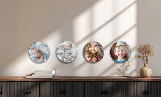 The round glass wall art shows kids and a baby and is a custom kids glass art gift idea and wonderful nursery decor and baby photo art
