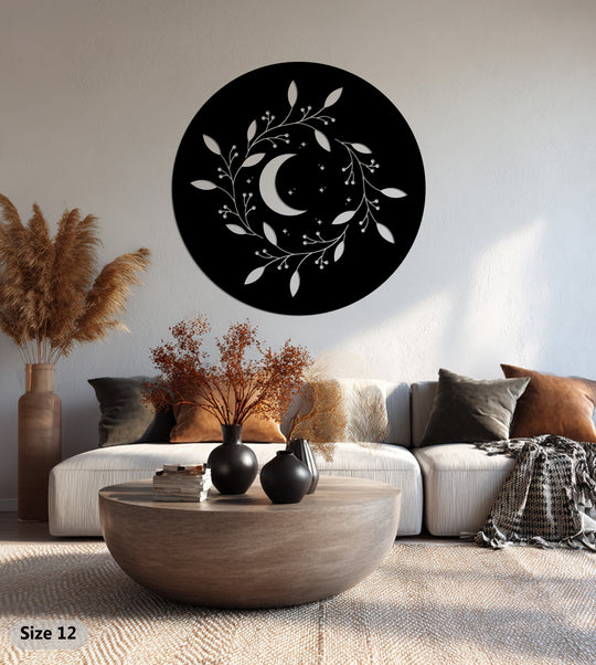 Illuminated by sunlight, the circular celestial crescent wreath metal wall decor showcases a round moon with a botanical design, a unique piece of metal wall decor.