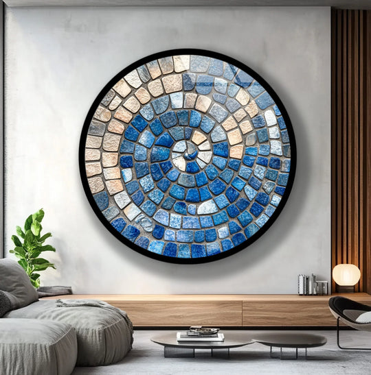 Geometric, circular ocean spiral mosaic features concentric rings of blue and sand-colored glass wall prints, creating a captivating and serene design.