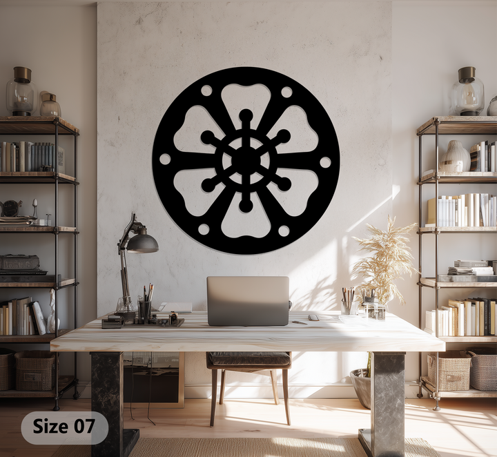 Featuring distressed walls in the background, this setting displays abstract wheel pattern round black metal artwork as part of the room's overall decor.